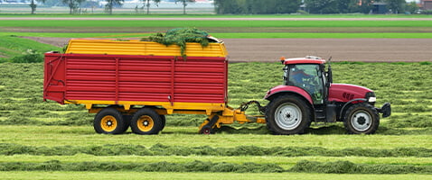 Red Tractor Pulling Grain Wagon / Cart